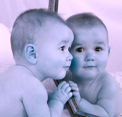  baby looking at self in mirror 
