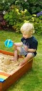  child playing in sandbox 
